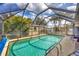 View of the private screened in pool with cozy chairs at 392 Yeager St, Port Charlotte, FL 33954