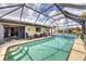 Enjoy the private screened in pool with lounge chairs for ultimate relaxation at 392 Yeager St, Port Charlotte, FL 33954