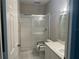 Bathroom with a tile floor, white vanity, and glass-enclosed shower at 3958 Mediterranea Cir # 411, Sarasota, FL 34233