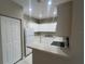 Well-lit kitchen featuring white cabinets and appliances at 3958 Mediterranea Cir # 411, Sarasota, FL 34233