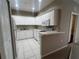 Well-maintained kitchen with white cabinets, appliances and tiled floor at 3958 Mediterranea Cir # 411, Sarasota, FL 34233