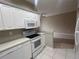 Clean kitchen with white cabinets and appliances at 3958 Mediterranea Cir # 411, Sarasota, FL 34233