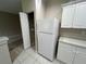 Clean kitchen features new white refrigerator, shelving and convenient access to the living area at 3958 Mediterranea Cir # 411, Sarasota, FL 34233