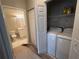 Convenient laundry room features a washer, dryer and storage next to the bathroom at 3958 Mediterranea Cir # 411, Sarasota, FL 34233
