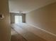 A large living room featuring neutral walls, a ceiling fan and access to outdoor patio at 3958 Mediterranea Cir # 411, Sarasota, FL 34233