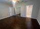 A spacious main bedroom includes hard wood floors, a mirror closet, and ensuite bathroom at 3958 Mediterranea Cir # 411, Sarasota, FL 34233