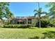 Lush backyard with a screened patio, manicured lawn, mature trees, and well-maintained landscaping at 4141 Entrada Ct, Sarasota, FL 34238