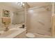 Neutral bathroom featuring a white vanity, framed mirror, and a shower/tub with frosted sliding glass door at 4141 Entrada Ct, Sarasota, FL 34238