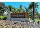 Prominent Palmer Ranch stone entrance sign, enhanced by vibrant flowers and tropical palm trees at 4141 Entrada Ct, Sarasota, FL 34238