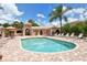 Community pool area including lounge chairs, umbrellas, palm trees, and attractive amenities at 4141 Entrada Ct, Sarasota, FL 34238