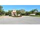 Main gate to the Mira Lago community, featuring a guard house and manicured landscaping at 4141 Entrada Ct, Sarasota, FL 34238