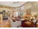 Cozy living room featuring hardwood floors, high ceilings, comfortable seating arrangement, and unique decor at 4141 Entrada Ct, Sarasota, FL 34238