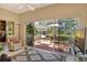 Open living area featuring tiled flooring, a ceiling fan, and access to a screened lanai at 4141 Entrada Ct, Sarasota, FL 34238