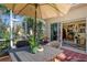 Relaxing screened patio with wicker furniture, potted plants, and inviting outdoor living space at 4141 Entrada Ct, Sarasota, FL 34238