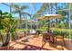 Enclosed patio area features a table with seating and offers a view of the manicured backyard at 4141 Entrada Ct, Sarasota, FL 34238