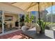 Inviting screened patio featuring stylish furniture, plants, and seamless indoor-outdoor flow at 4141 Entrada Ct, Sarasota, FL 34238
