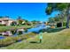 Water view overlooking a serene pond, community landscaping, and surrounding homes at 4141 Entrada Ct, Sarasota, FL 34238
