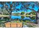 Scenic view from a bench overlooking a pond reflecting the surrounding trees and homes at 4141 Entrada Ct, Sarasota, FL 34238