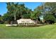 Community sign for Mira Lago set amidst lush landscaping and a manicured lawn at 4141 Entrada Ct, Sarasota, FL 34238