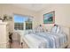 Bedroom with two twin beds, bright window, coastal art, and a light color scheme at 4210 Overture Cir, Bradenton, FL 34209
