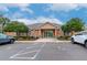 Exterior view of the community clubhouse with parking and surrounding landscape at 4210 Overture Cir, Bradenton, FL 34209