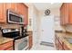 Well-lit kitchen featuring stainless steel appliances and granite countertops at 4210 Overture Cir, Bradenton, FL 34209