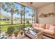 Screened lanai overlooking a serene pond with lush landscaping and palm trees offering a relaxing outdoor space at 4210 Overture Cir, Bradenton, FL 34209