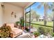 Cozy screened-in lanai, perfect for relaxation with comfortable seating and views of the landscaped backyard at 4210 Overture Cir, Bradenton, FL 34209