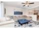 Comfortable living room featuring a large sectional sofa, stylish rug, and elegant ceiling fan at 4210 Overture Cir, Bradenton, FL 34209
