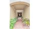 Brick hallway leading to a door, flanked by garden beds at 4210 Overture Cir, Bradenton, FL 34209