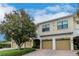 Tan condo building with a light brown brick parking area and a large green tree in the front at 4210 Overture Cir, Bradenton, FL 34209