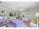 Cozy bedroom with pastel walls, colorful rug, and comfortable seating at 425 Poincianna Dr, Sarasota, FL 34243