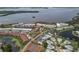 Stunning aerial view showcasing the waterfront community, pool, tennis courts, and lush landscaping at 4753 Independence Dr, Bradenton, FL 34210