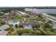 Aerial view of the community featuring a pool, clubhouse, and lush landscaping near the water at 4753 Independence Dr, Bradenton, FL 34210