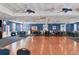 Spacious ballroom featuring a wood dance floor, blue walls, ceiling fans, and ample seating for events at 4753 Independence Dr, Bradenton, FL 34210