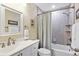 Bathroom showcasing a tub and shower combo, modern fixtures and a decorative mirror at 4753 Independence Dr, Bradenton, FL 34210
