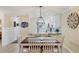 Dining area featuring a modern chandelier, seating for six, and white wainscotting at 4753 Independence Dr, Bradenton, FL 34210