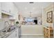 Open kitchen featuring white cabinets, granite countertops, and stainless steel appliances overlooking the great room at 4753 Independence Dr, Bradenton, FL 34210