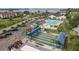 Aerial view of shuffleboard courts with covered seating and nearby parking in this active community at 4753 Independence Dr, Bradenton, FL 34210