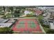 Aerial view of tennis courts with players in a community surrounded by lush landscaping at 4753 Independence Dr, Bradenton, FL 34210