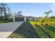 Charming single-story home featuring a manicured lawn and an attached two-car garage at 4793 Lovett Rd, North Port, FL 34288