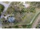 Aerial view of the house, pool, and surrounding treed lot at 4871 Hoyer Dr, Sarasota, FL 34241