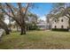 Expansive backyard featuring a screened-in pool area and lush greenery, ideal for outdoor enjoyment and relaxation at 4871 Hoyer Dr, Sarasota, FL 34241