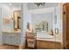 Bright bathroom featuring marble countertops, soaking tub with large window, and glass enclosed shower at 4871 Hoyer Dr, Sarasota, FL 34241