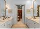 Bright bathroom with dual sinks, marble countertops, decorative wall art, and a dressing table at 4871 Hoyer Dr, Sarasota, FL 34241