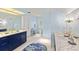 Spacious blue bathroom with modern vanities, elegant lighting, and tile flooring at 4871 Hoyer Dr, Sarasota, FL 34241