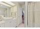 Bathroom featuring modern vanity, quartz countertops, and a shower with a curtain at 4871 Hoyer Dr, Sarasota, FL 34241