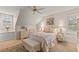 Comfortable bedroom with sloped ceilings, neutral tones, and cozy decor at 4871 Hoyer Dr, Sarasota, FL 34241