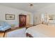 Bright bedroom featuring hardwood floors, ceiling fan, and a closet with sliding doors at 4871 Hoyer Dr, Sarasota, FL 34241