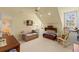 Bedroom with a cozy couch, rocking chair, desk, and charming decor accents at 4871 Hoyer Dr, Sarasota, FL 34241